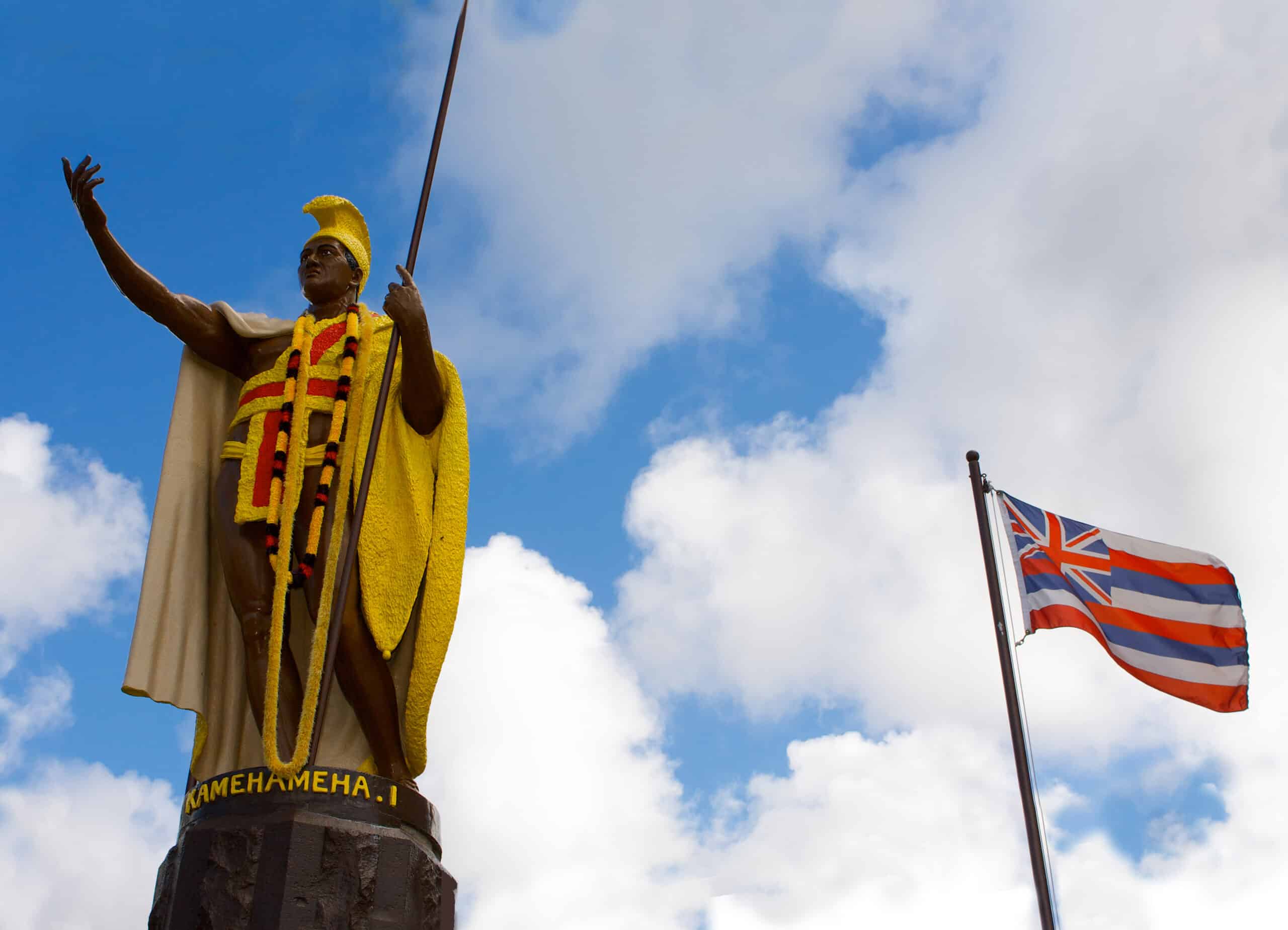Kamehameha Statue and flag scaled - Kohala Pacific Realty